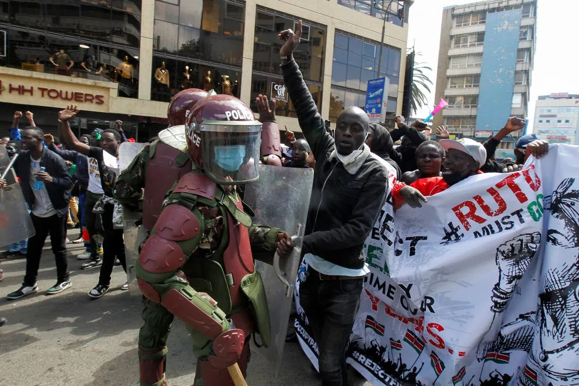 Demonstrators react as police stand guard during a demonstration against Kenya's proposed finance bill 2024/2025 in Nairobi, Kenya, June 25, 2024. REUTERS/Monicah Mwangi/ File Photo