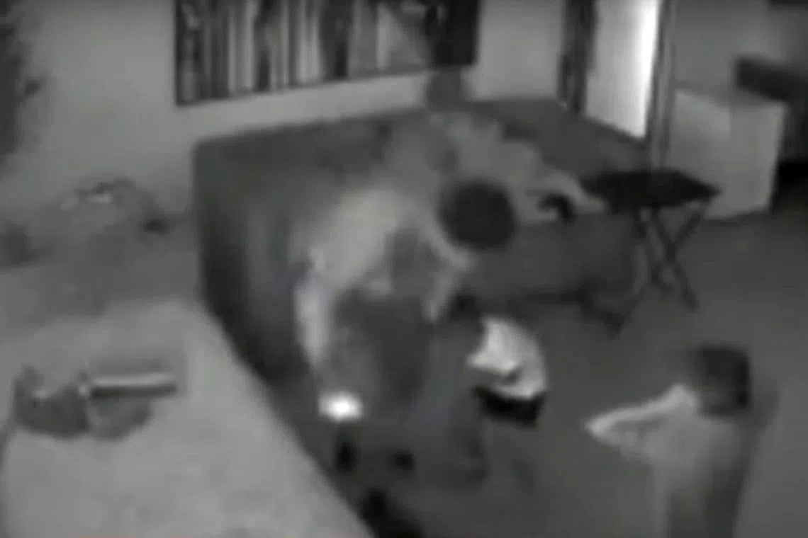 A man is seen watching something on his laptop when a shot is fired, covering the toddler’s hand in blood.