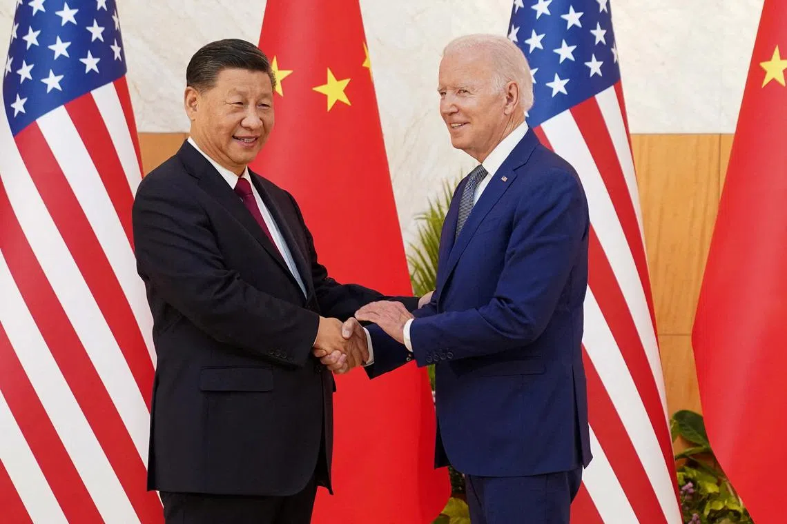 U.S. President Joe Biden shakes hands with Chinese President Xi Jinping as they meet on the sidelines of the G20 leaders' summit in Bali, Indonesia, November 14, 2022.  REUTERS/Kevin Lamarque