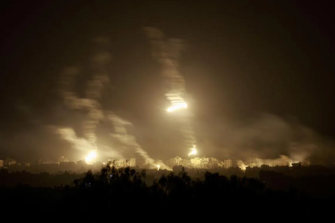 Flares burn in the sky over northern Gaza Strip amid the ongoing conflict between Israel and Palestinian Islamist group Hamas, as seen from Sderot in southern Israel, November 7, 2023. REUTERS/Ammar Awad