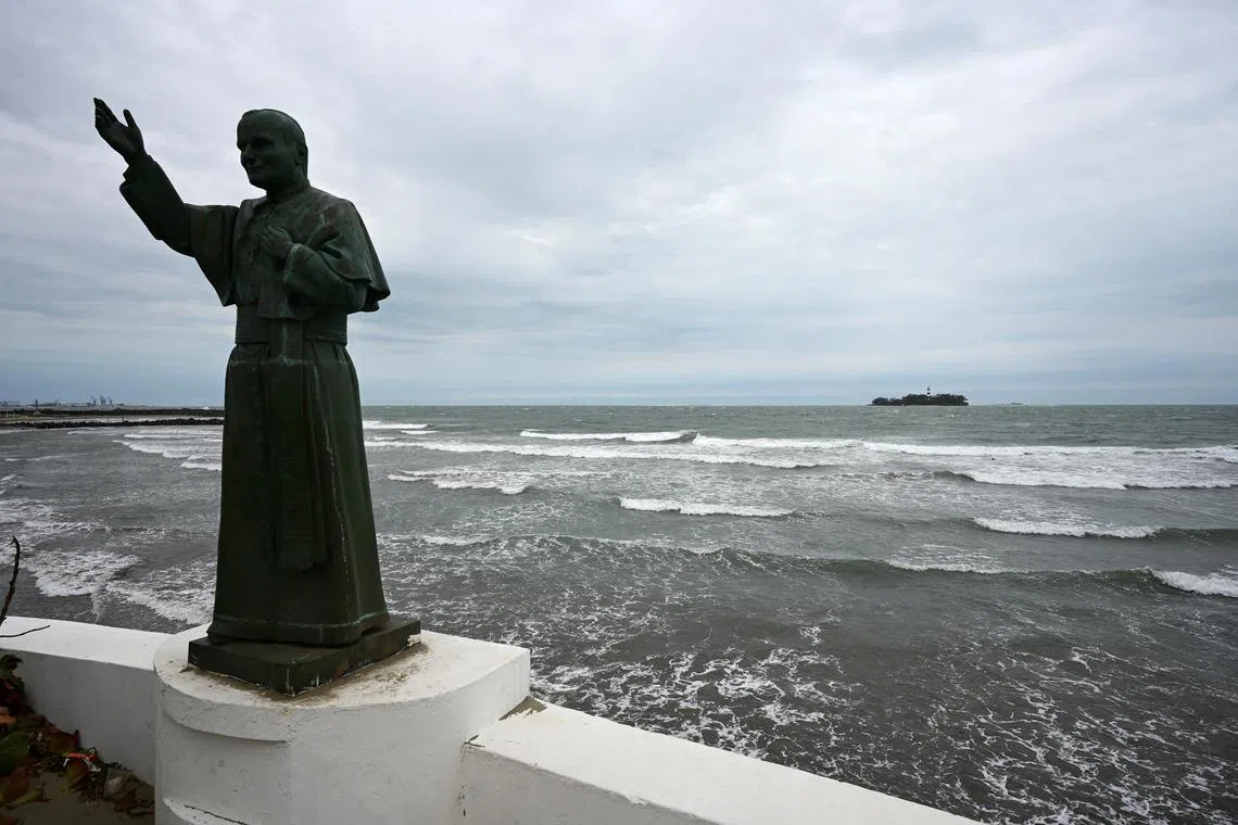 FILE PHOTO: A statue of pope John Paul II is seen at a jetty as waves crash on the shore of the Gulf of Mexico, after newly sworn-in U.S. President Donald Trump signed an executive order to change the name of the Gulf of Mexico to the Gulf of America, in Boca del Rio, Veracruz state, Mexico January 21, 2025. REUTERS/Yahir Ceballos/File Photo