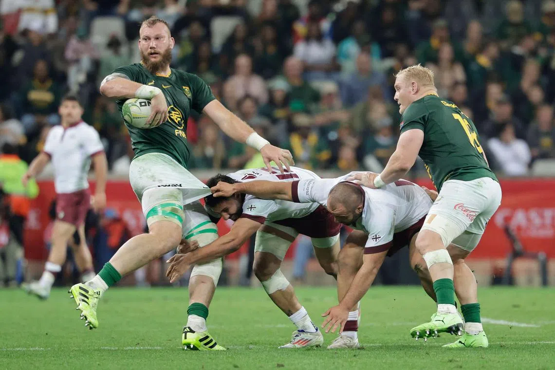 Georgia's centre Giorgi Kveseladze (second from left) tackles South Africa's lock R.G. Snyman in their rugby Test in Mbombela on July 19, 2025.
