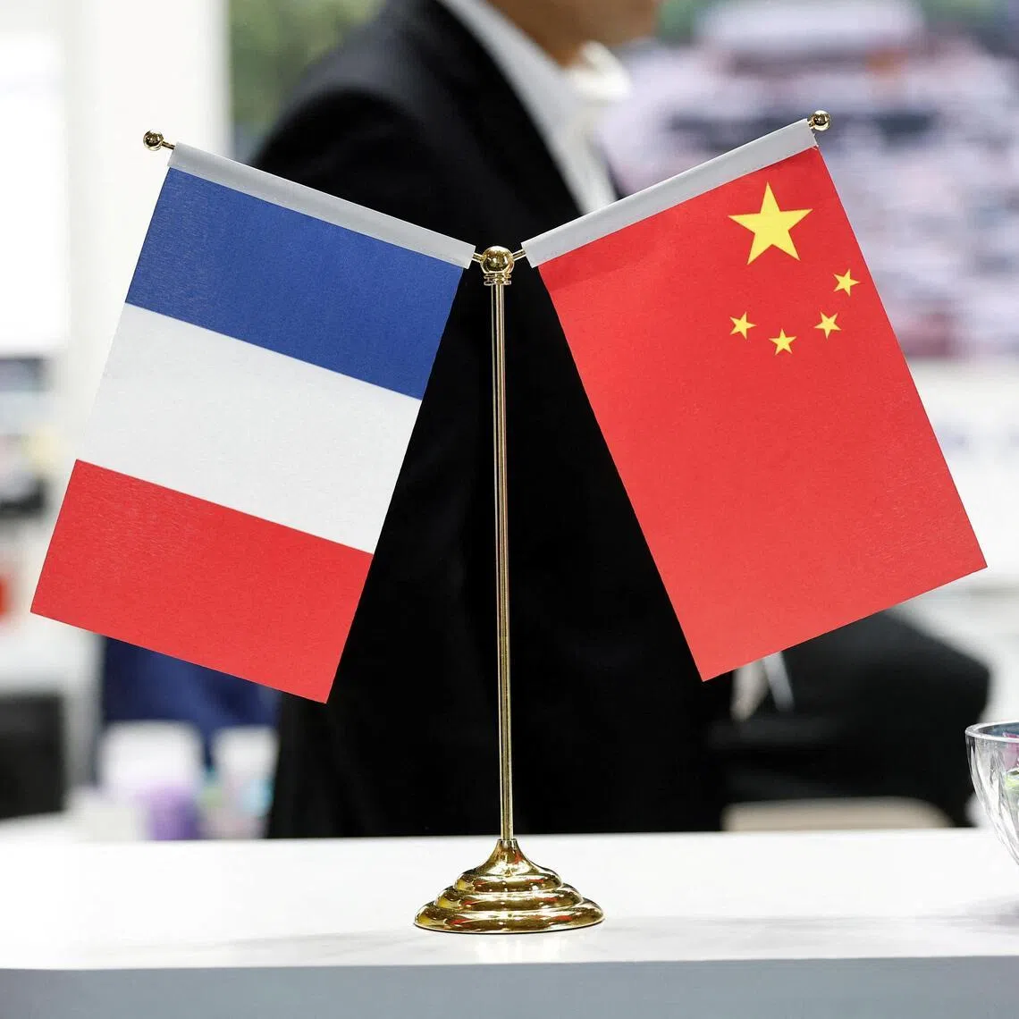 FILE PHOTO: French and Chinese flags are seen at the Wuxi Turbine Blade Co., Ltd stand during the 55th International Paris Airshow at Le Bourget Airport near Paris, France, June 16, 2025. REUTERS/Benoit Tessier/File Photo