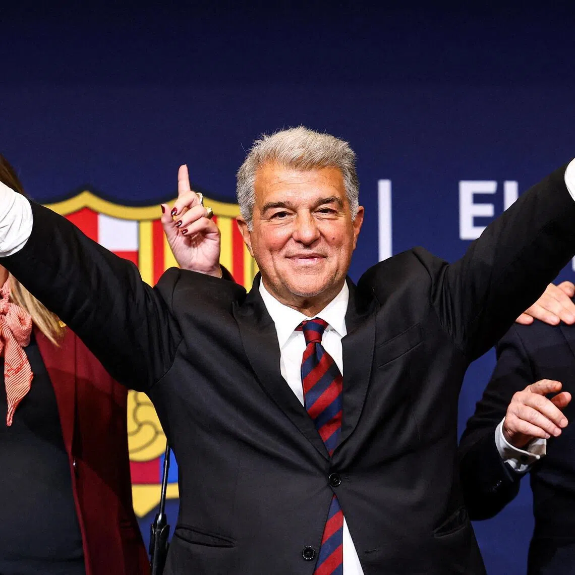 Joan Laporta celebrates his victory after being re-elected as Barcelona president alongside his board members.