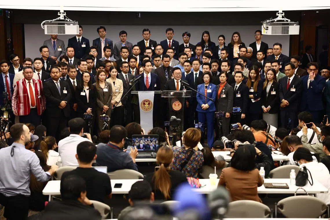 Former Thai prime ministerial candidate and Move Forward Party (MFP) MP Pita Limjaroenrat (C) attends a press conference at the Thai parliament in Bangkok on January 31, 2024, after Thailand's Constitutional Court court ordered Pita and MFP to stop campaigning for lese-majeste reform immediately. Thailand's progressive Move Forward Party, which won most seats at the last election, was on January 31 ordered to stop campaigning to reform the kingdom's tough royal defamation laws, as a top court ruled the policy was unlawful. (Photo by Jack TAYLOR / AFP)