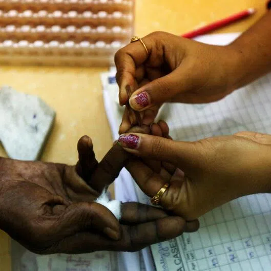 A government health worker collects blood sample from a patient at a dengue detention centre in Kolkata, India.