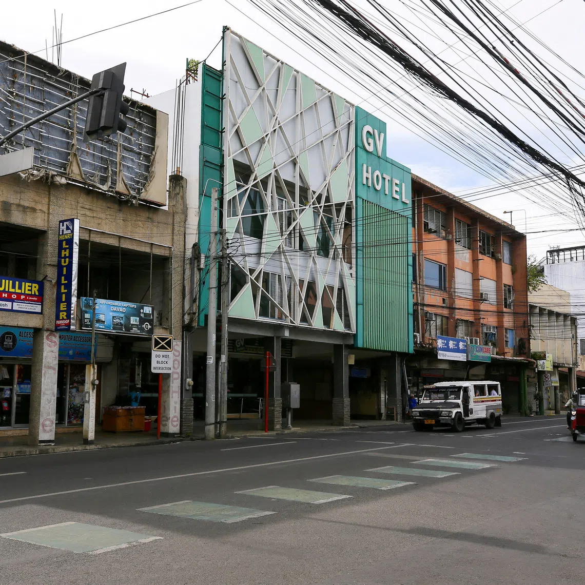 Vehicles pass next to the exterior of GV Hotel where the suspected gunmen from Sydney's Bondi Beach shooting attack at a Hanukkah event had allegedly stayed when they travelled to the Philippines last month, in Davao City, Philippines, December 17, 2025. REUTERS/Marconi B. Navales