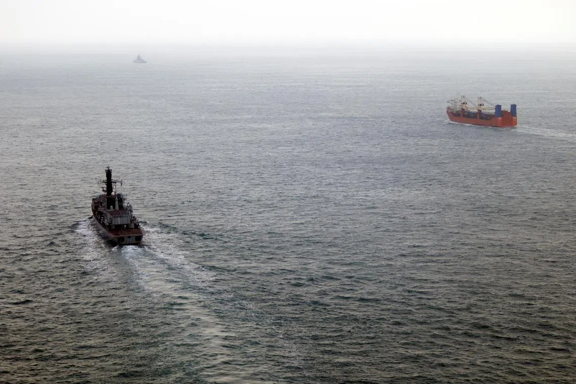 A British Navy frigate (left) monitoring the movement of what it said was a Russian warship escorting a merchant vessel through UK waters.