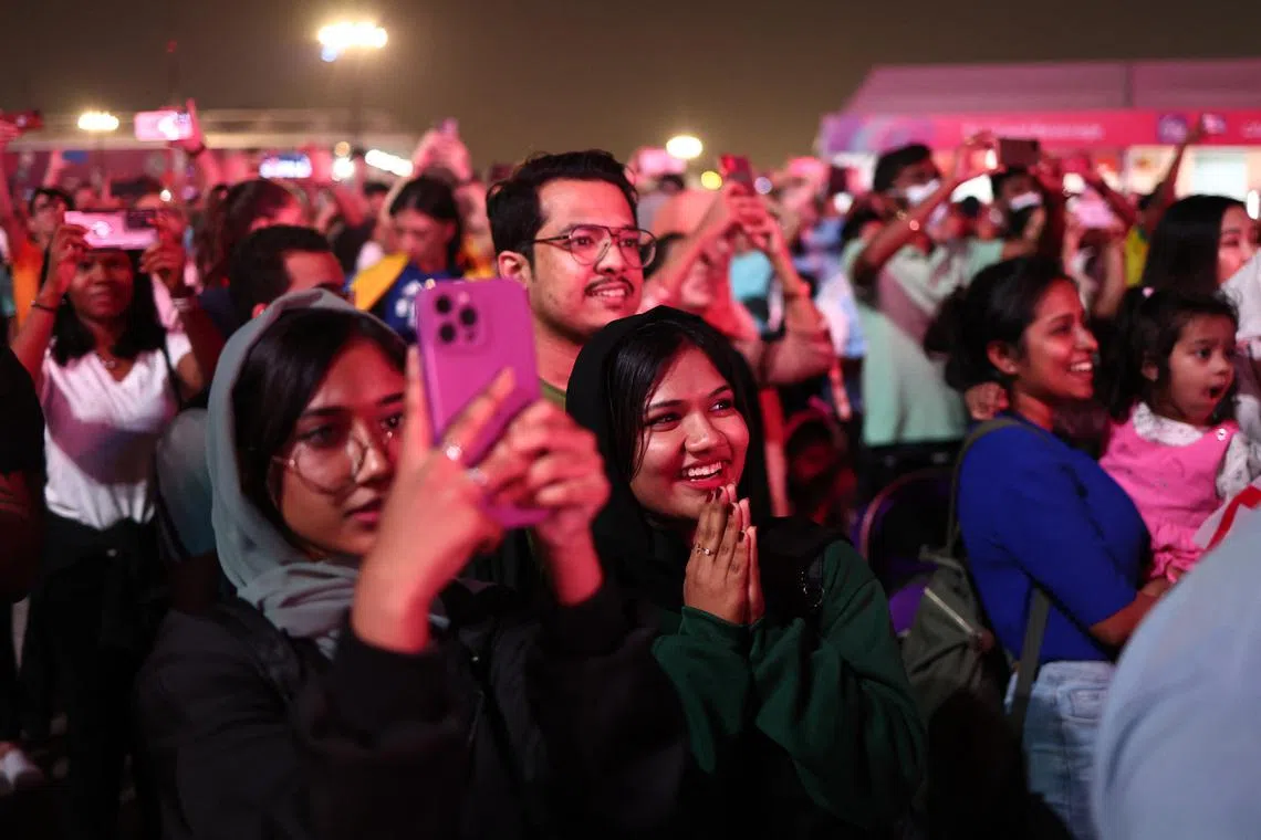 Soccer Football - FIFA World Cup Qatar 2022 - FIFA Fan Festival Opening - FIFA Fan Festival at Al Bidda Park, Doha, Qatar - November 19, 2022 Fans watching a stage during the opening of the FIFA fan festival REUTERS/Marko Djurica