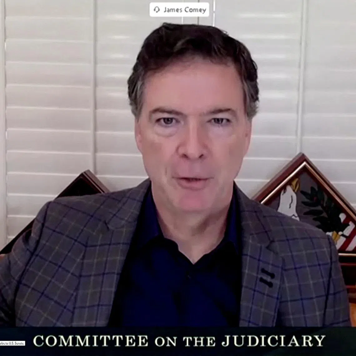 FILE PHOTO: James Comey, former director of the Federal Bureau of Investigation (FBI), is seen in a frame grab from a video feed as he is sworn in remotely from his home during a Senate Judiciary Committee hearing exploring the FBI's investigation of the 2016 Trump campaign and Russian election interference in Washington, U.S., September 30, 2020. U.S. Senate Committee on the Judiciary/Handout via REUTERS/File Photo
