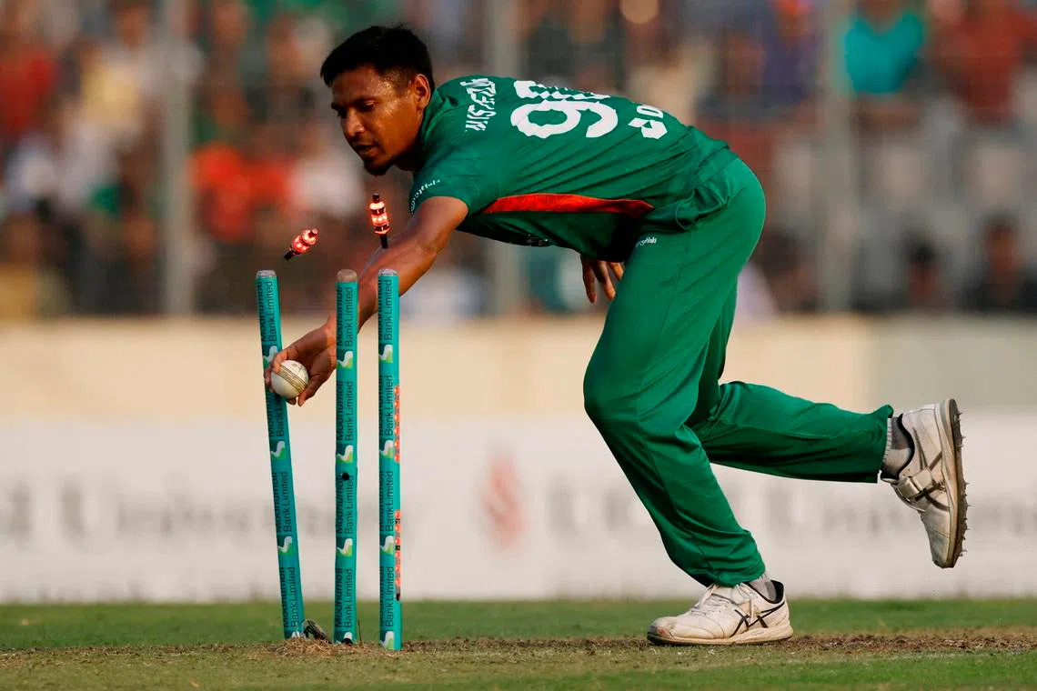 Cricket - Second Twenty20 - Bangladesh v England - Sher-E-Bangla National Cricket Stadium, Dhaka, Bangladesh - March 12, 2023 Bangladesh's Mustafizur Rahman runs out England's Jofra Archer REUTERS/Adnan Abidi