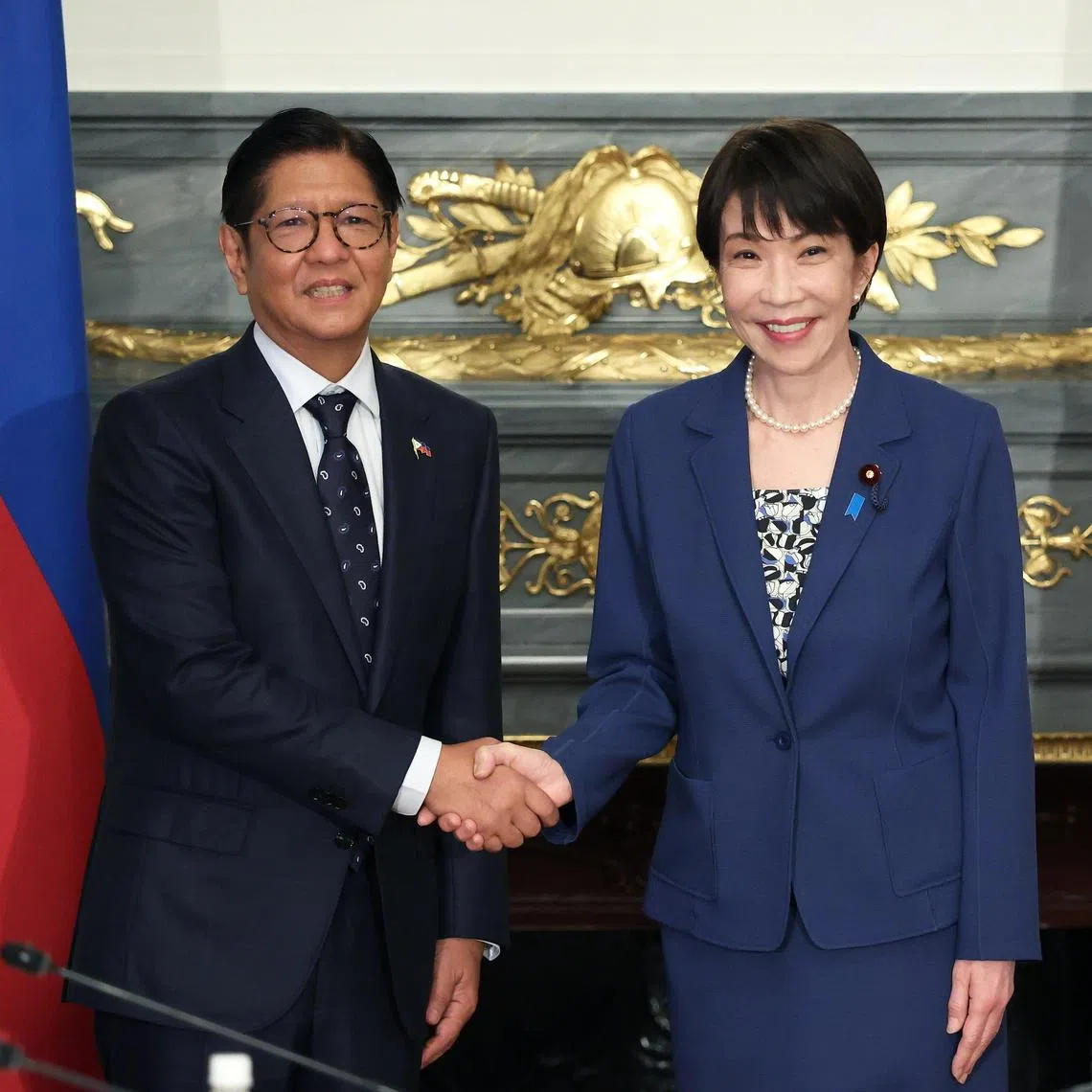 epa12999742 Japan's Prime Minister Sanae Takaichi (R) and Philippines' President Ferdinand Marcos Jr. (L) shake hands before a summit meeting at the Akasaka Palace state guest house in Tokyo, Japan, 28 May 2026.  EPA/Kiyoshi Ota / POOL
