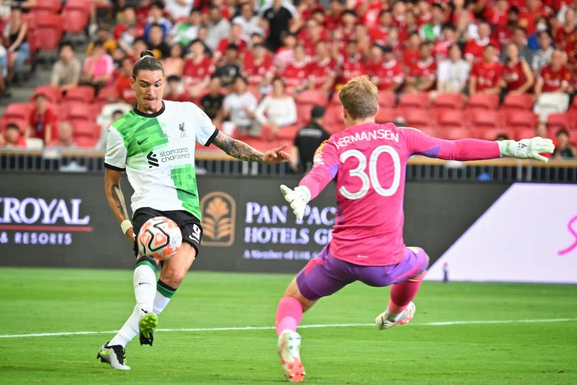 Liverpool's Darwin Nunez attempts to chip the ball past Leicester City goalkeeper Mads Hermansen at the National Stadium on July 30, 2023.
