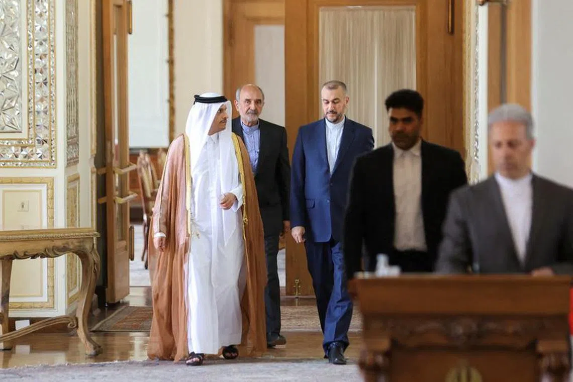 FILE PHOTO: Iran's Foreign Minister Hossein Amir-Abdollahian and Qatari Deputy Prime Minister and Foreign Minister Sheikh Mohammed bin Abdulrahman Al Thani enter a hall for a joint news conference, in Tehran, Iran July 6, 2022. Majid Asgaripour/WANA (West Asia News Agency) via REUTERS ATTENTION EDITORS - THIS PICTURE WAS PROVIDED BY A THIRD PARTY/File Photo