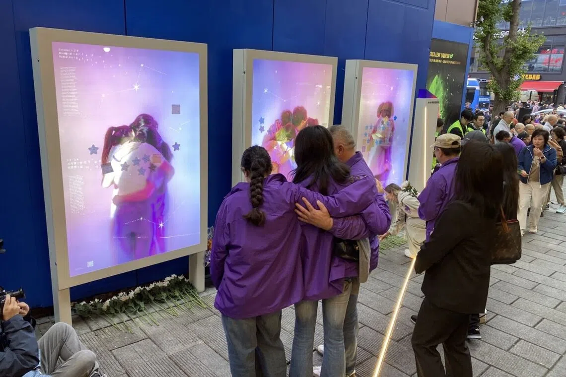 Family members of Grace Rashed, an Australian who died in the 2022 Itaewon crowd crush, in front of a memorial site for the disaster on Oct 24.