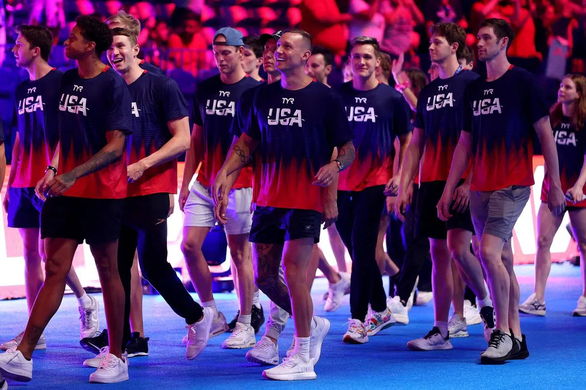 Caeleb Dressel and the United States swimming team walk by the fans on the last day of the US Olympic trials.