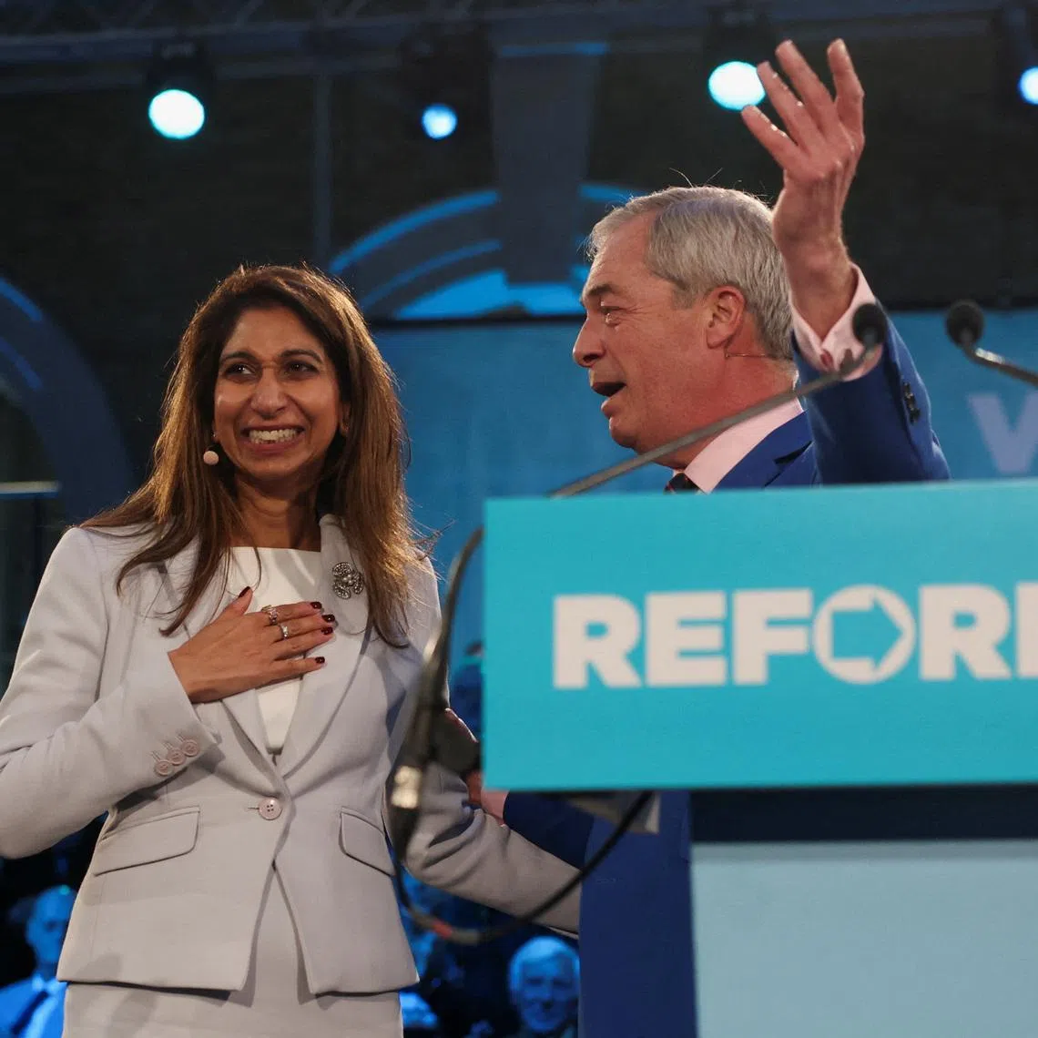 Former British Home Secretary Suella Braverman, who today announced she has defected from the Conservative Party to Reform UK, reacts next to Britain's Reform UK leader Nigel Farage at a Veterans for Reform press launch, in London, Britain, January 26, 2026. REUTERS/Isabel Infantes