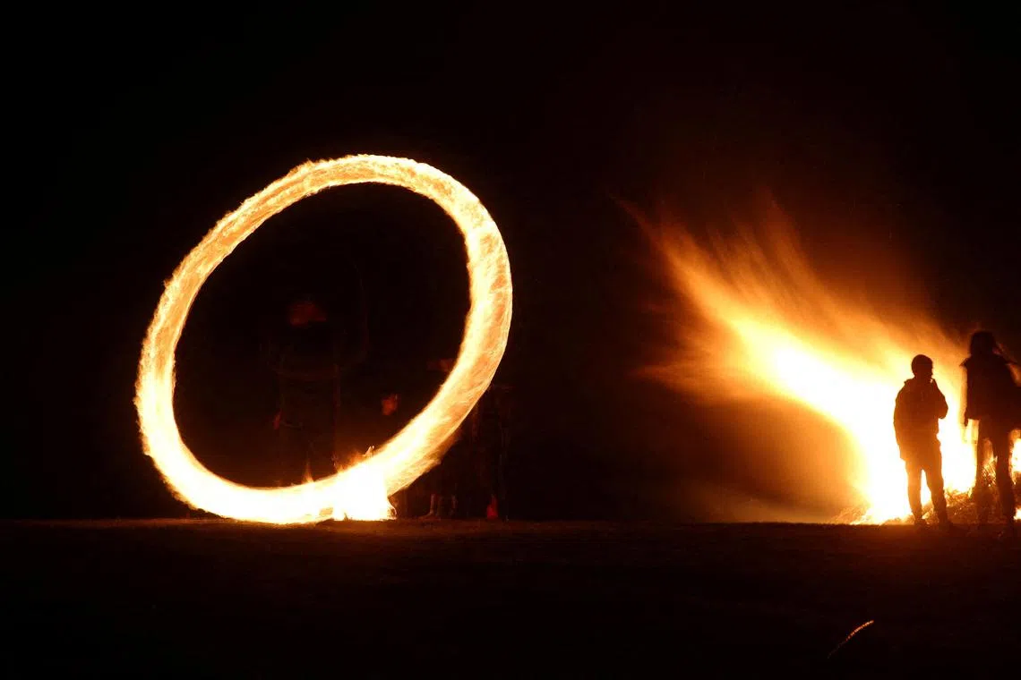 A child spinning ring of fire during rituals in celebration of Sirni Zagovezni, the second Sunday before Great Lent, in Lozen, Bulgaria, Feb 26, 2023. 