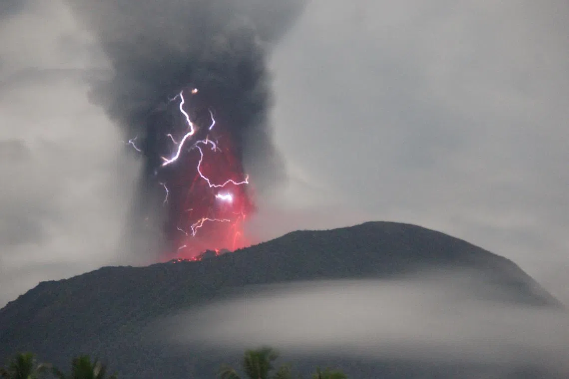 Lightning appears amid a storm as Mount Ibu spews volcanic material during an eruption, as seen from Gam Ici in West Halmahera, North Maluku province, Indonesia, May 18, 2024 in this handout image. The Center for Volcanology and Geological Hazard Mitigation (PVMBG)/Handout via REUTERS