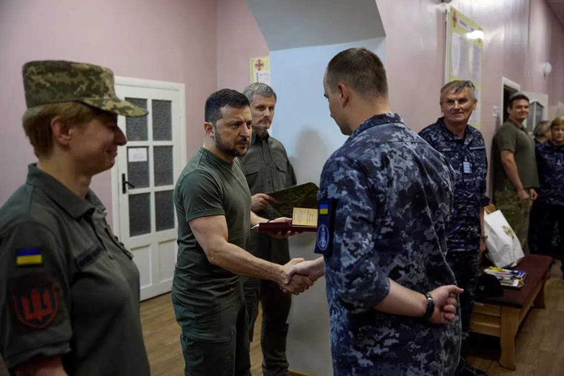 Ukraine's President Volodymyr Zelenskiy awards Ukrainian service members as he visits a military hospital in the town of Ochakiv, amid Russia's attack on Ukraine, in Mykolaiv region, Ukraine July 27, 2023. Ukrainian Presidential Press Service/Handout via REUTERS /FILE PHOTO