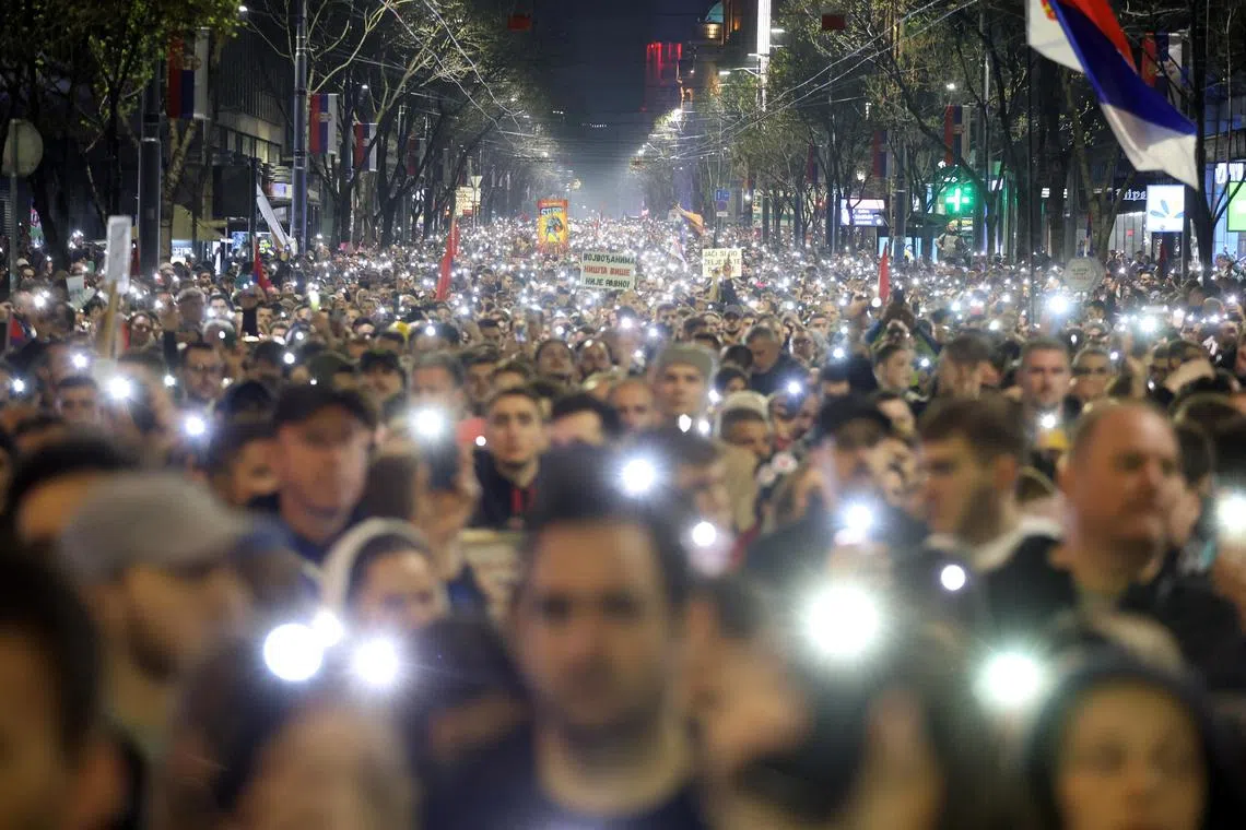Protesters holding 15 minutes of silence on March 15 in Belgrade to remember the victims of the railway station disaster in Serbia's Novi Sad. 
