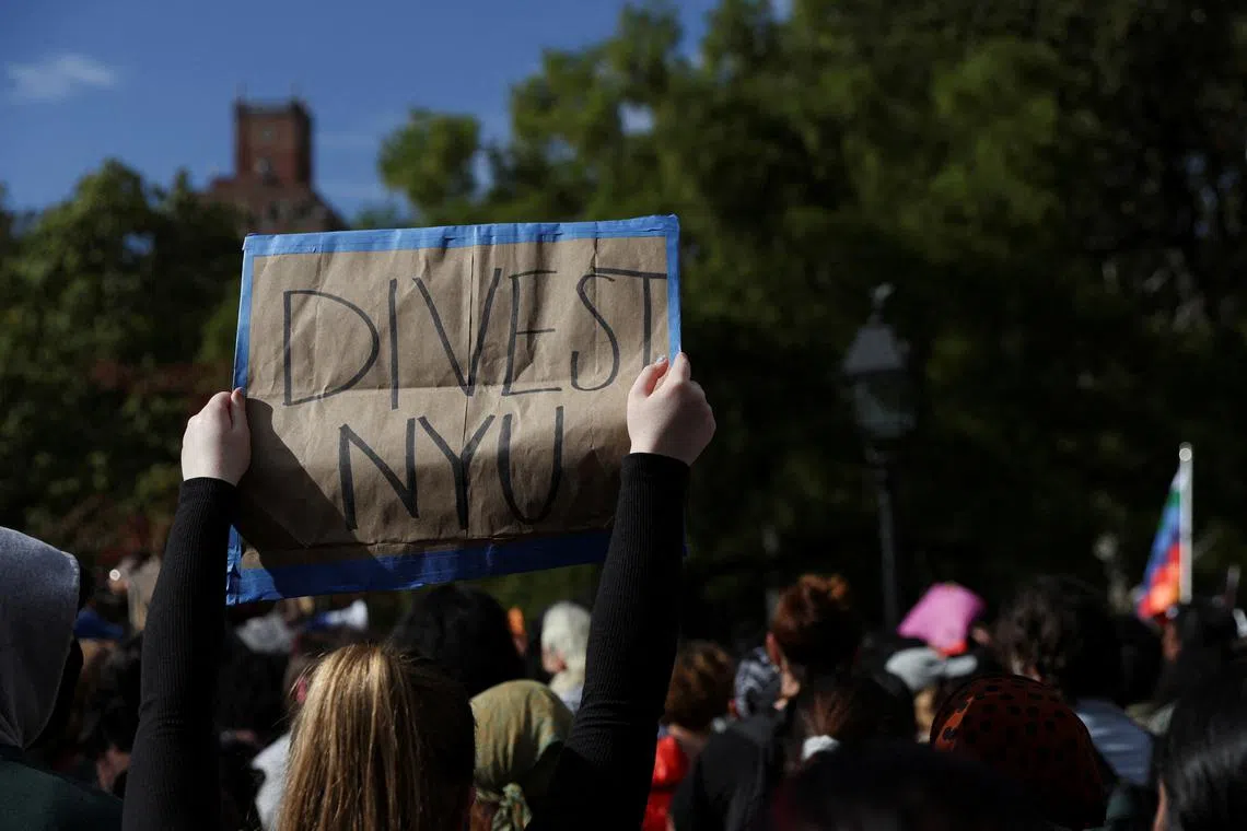 FILE PHOTO: A person holds a sign as people attend a demonstration to express solidarity with Palestinians in Gaza, amid the ongoing conflict between Israel and Hamas, as part of a student walkout by students of New York University, in New York City, U.S., October 25, 2023. REUTERS/Shannon Stapleton/File Photo
