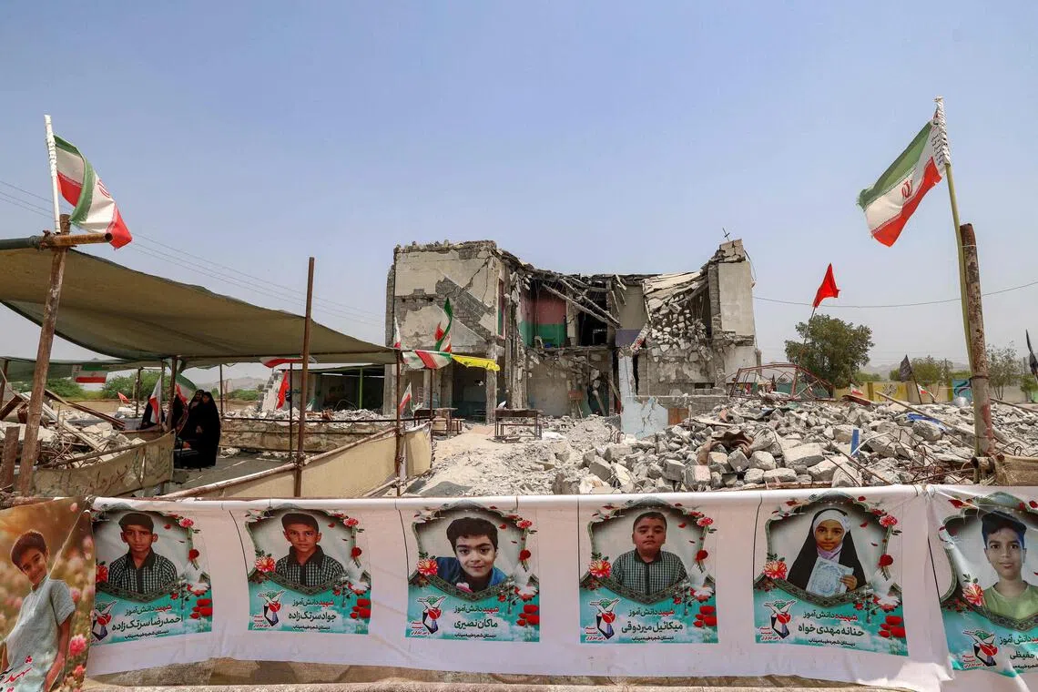 The Shajareh Tayebeh primary school which has remained largely in ruins, its collapsed walls and twisted steel now surrounded by portraits of the children killed.