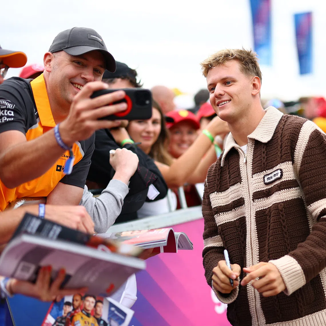 Formula One F1 - British Grand Prix - Silverstone Circuit, Silverstone, Britain - July 5, 2025 Alpine reserve driver Mick Schumacher takes photograph with fans ahead of practice REUTERS/Andrew Boyers