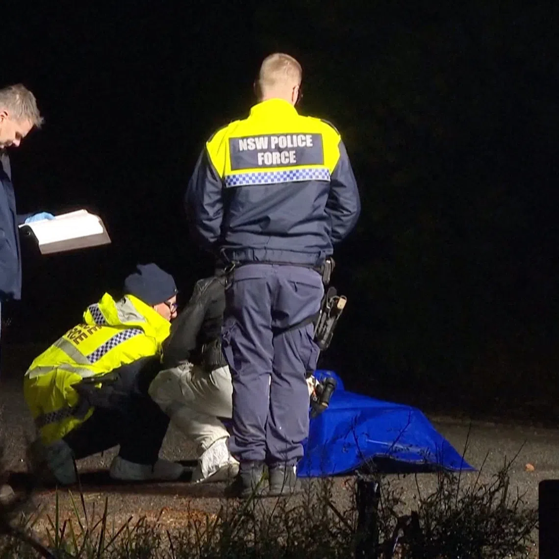 Police personnel present near a bag covered in plastic, the item in which was later determined as a life like doll and not remains of a human body, leading to the Australian police calling off a homicide investigation, in Oallen, New South Wales, Australia August 9, 2026, in this screengrab from a handout video. Australian Broadcasting Corporation/Handout via REUTERS