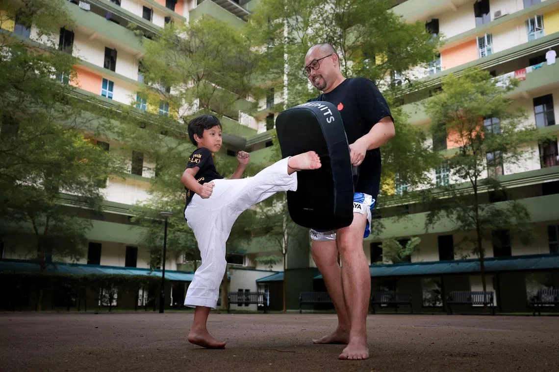 Mr Imran Johri, 50, and his son, Iden Lee Imran, 9, demonstrating their martial arts and self defence skills. Mr Imran taught his son to protect himself as he was badly bullied as a child, too. ST PHOTO: GAVIN FOO