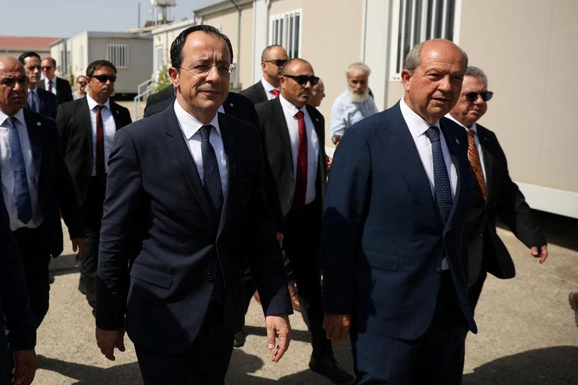 FILE PHOTO: Cyprus President Nikos Christodoulides and Turkish Cypriot leader Ersin Tatar, walk during a visit at the the CMP Anthropological Laboratory in the buffer zone of Nicosia airport, Cyprus July 28, 2023. REUTERS/Yiannis Kourtoglou/File Photo