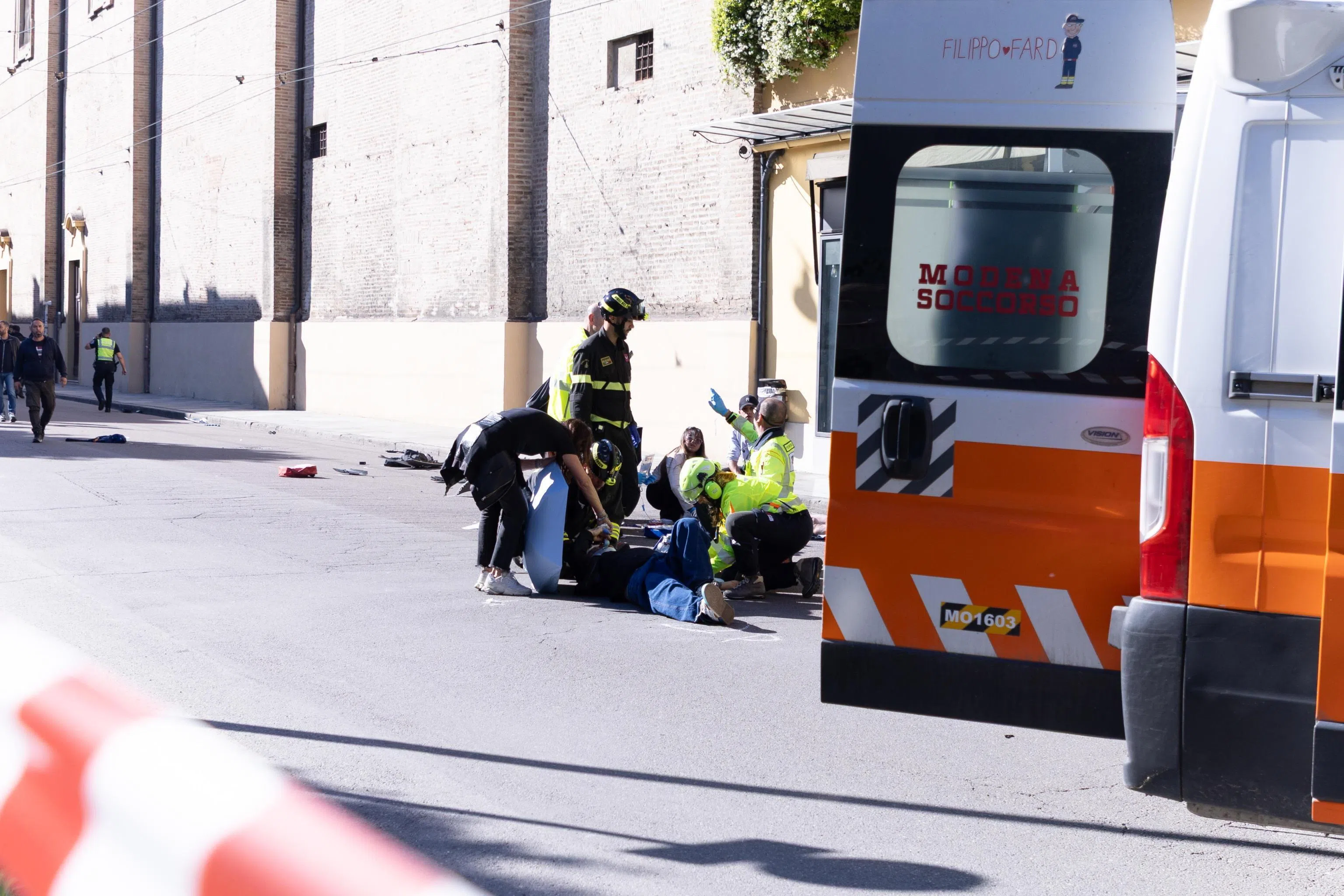 Law enforcement and emergency personnel working at the scene after a vehicle struck several pedestrians in downtown Modena, northern Italy, on May 16.