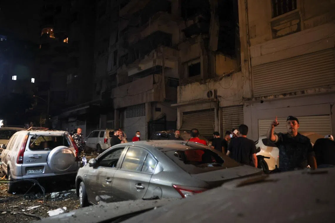 A large fire blazed in the background as rescue workers used torches to search the rubble for survivors.