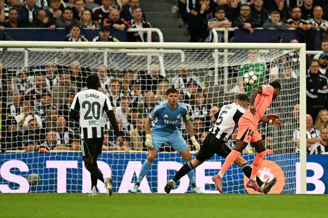 Barcelona forward Marcus Rashford (right) heads the ball to score his team's first goal.