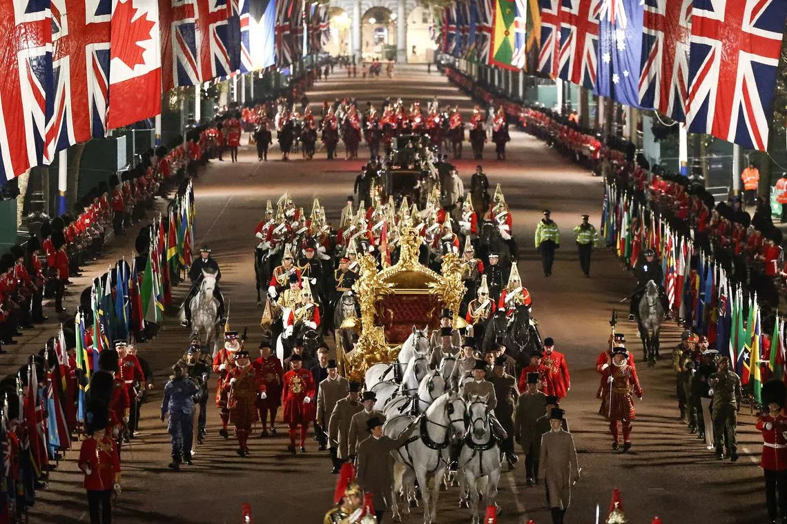 The Gold State Coach is ridden alongside members of the military during a full overnight dress rehearsal of the Coronation Ceremony of Britain’s King Charles and Camilla, Queen Consort in London, Britain, May 3, 2023. 