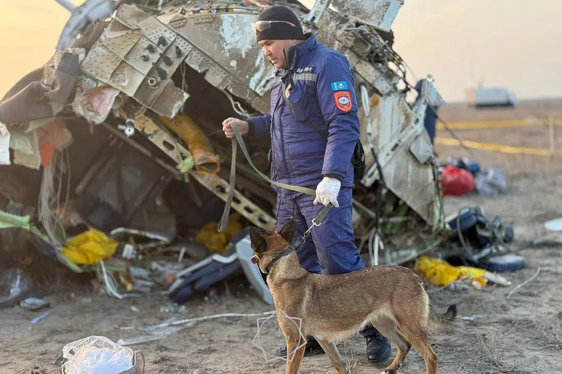 In this handout picture released by Kazakhstan's emergency situations ministry on Dec 26, emergency specialists work at the crash site of an Azerbaijan Airlines passenger jet near the western Kazakh city of Aktau.