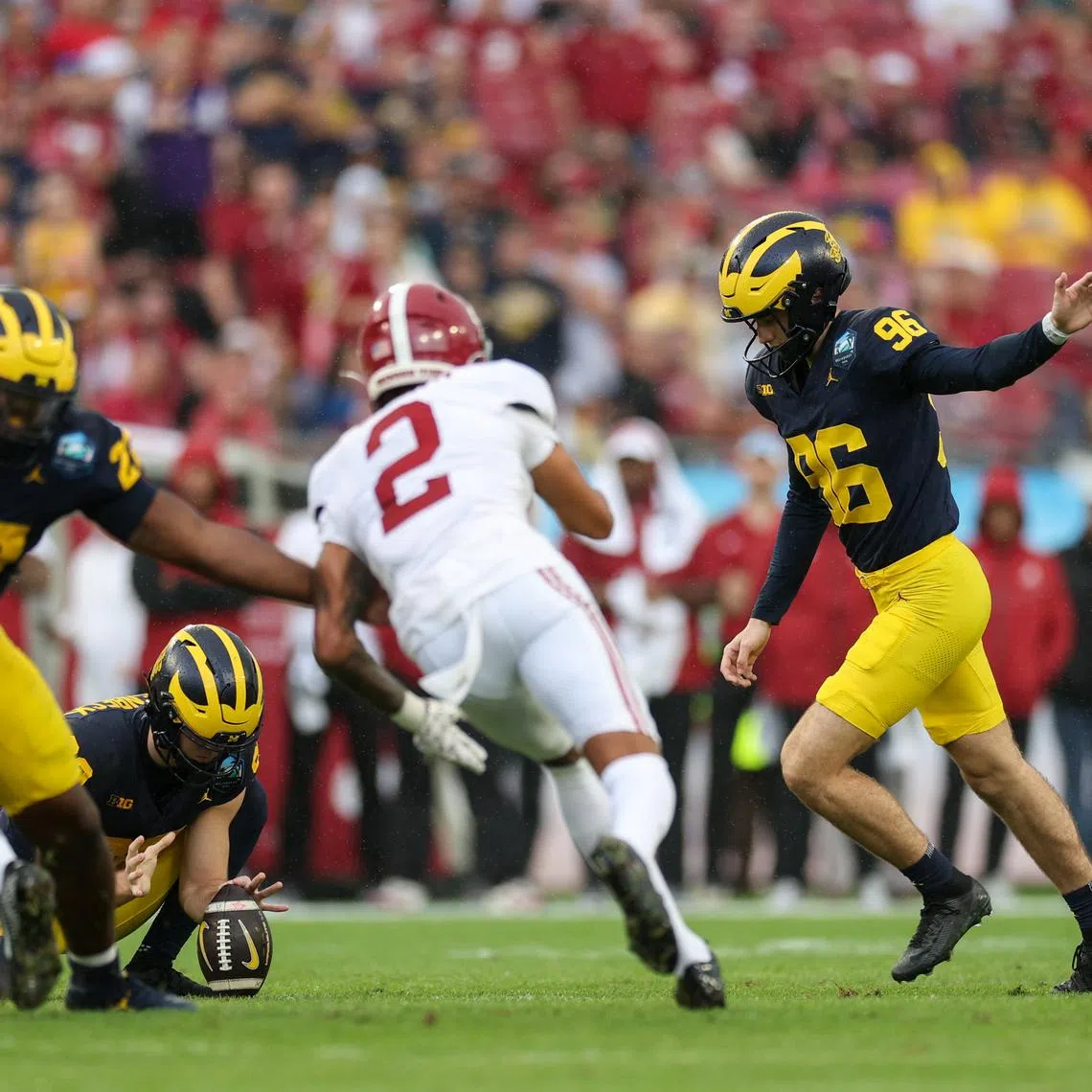 Dec 31, 2024; Tampa, FL, USA; Michigan Wolverines place kicker Dominic Zvada (96) kicks a field goal against the Alabama Crimson Tide in the first quarter during the ReliaQuest Bowl at Raymond James Stadium. Mandatory Credit: Nathan Ray Seebeck-Imagn Images