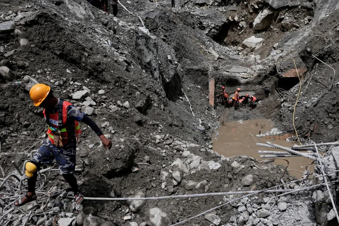 Rescue team members work to enter the tunnel at the Upper Trishuli 3A Hydropower Station as they search for survivors and retrieve bodies.