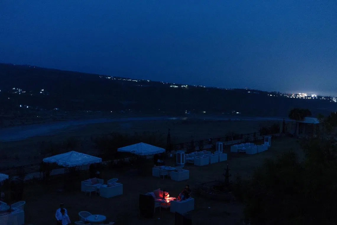 A family sitting in an open restaurant just before a suspected Pakistan attack in Jammu on May 8.