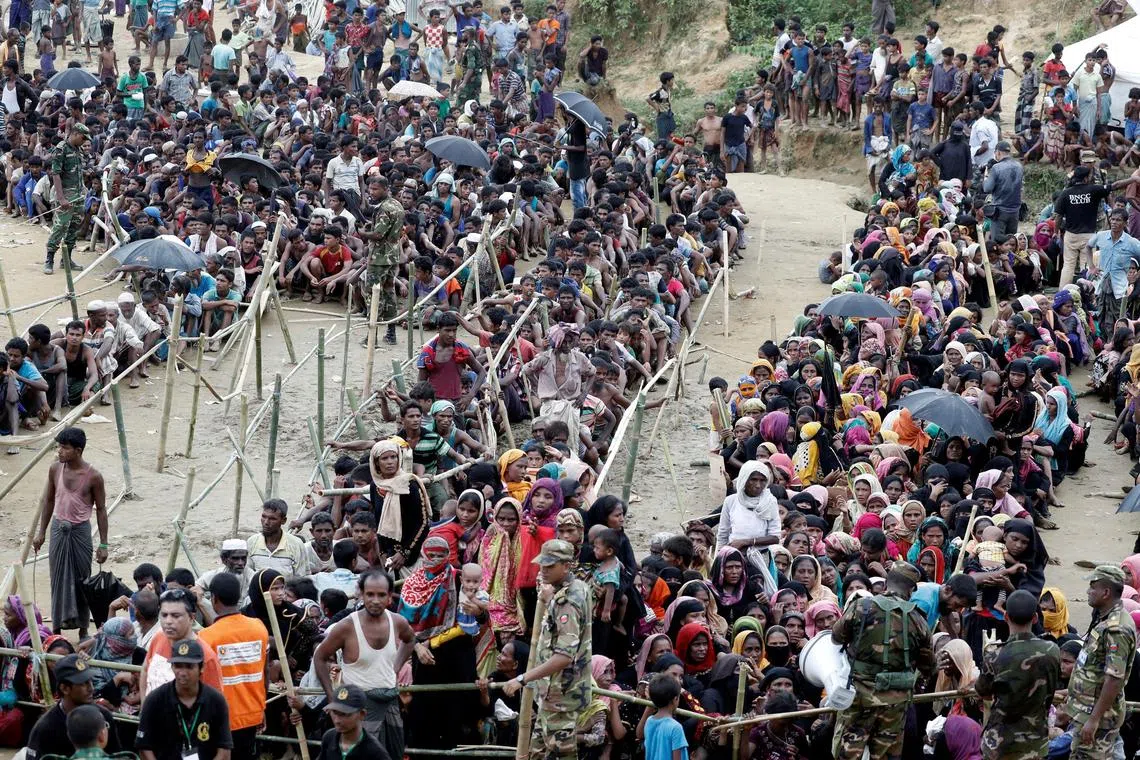 Rohingya refugees queue for aid at Cox's Bazar, Bangladesh, on Sept 26, 2017. 