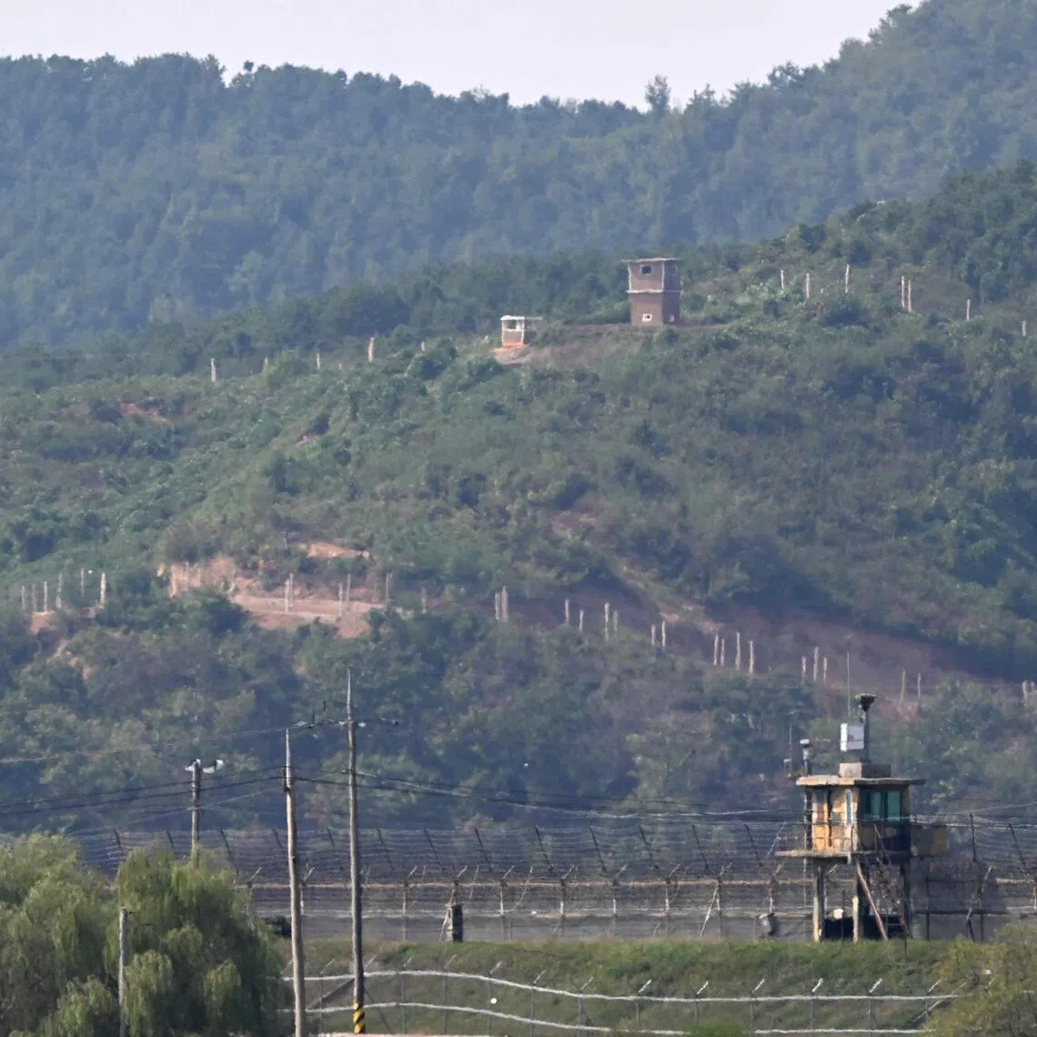 A North Korean guard post (top) and a South Korean one (bottom) at the Demilitarised Zone (DMZ) dividing the two sides seen from the border city of Paju on Sept 30. The North says it is not responsible for the recent explosion that severely injured three South Korean soldiers.