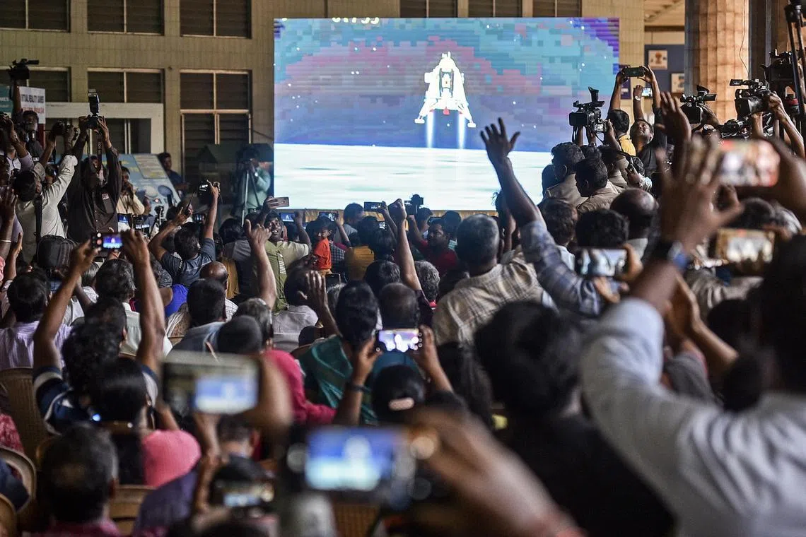 People in the Indian city of Chennai celebrate as lunar lander Vikram touches down after a 40-day journey to the moon.
