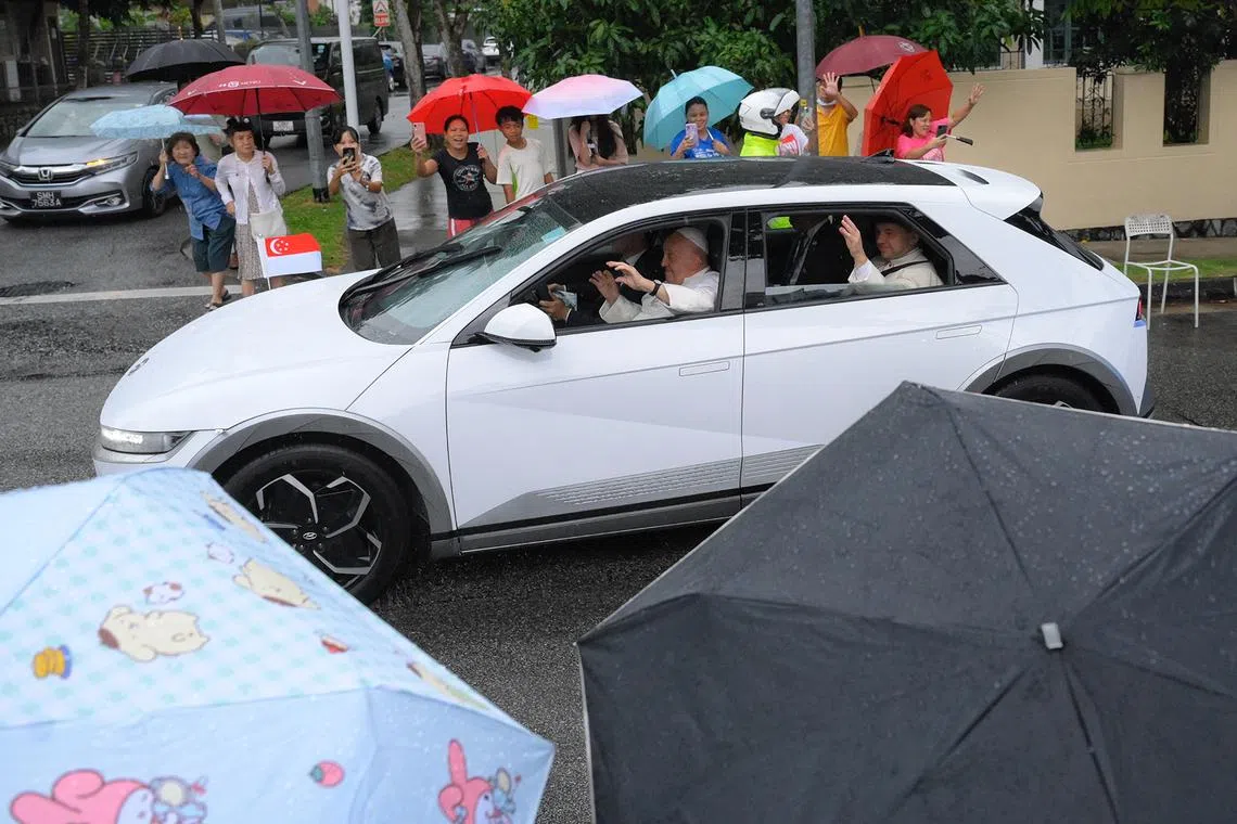 Pope Francis greeting well-wishers along Ponggol Seventeenth Avenue, near the St Francis Xavier Retreat Centre, on Sept 11, 2024. 