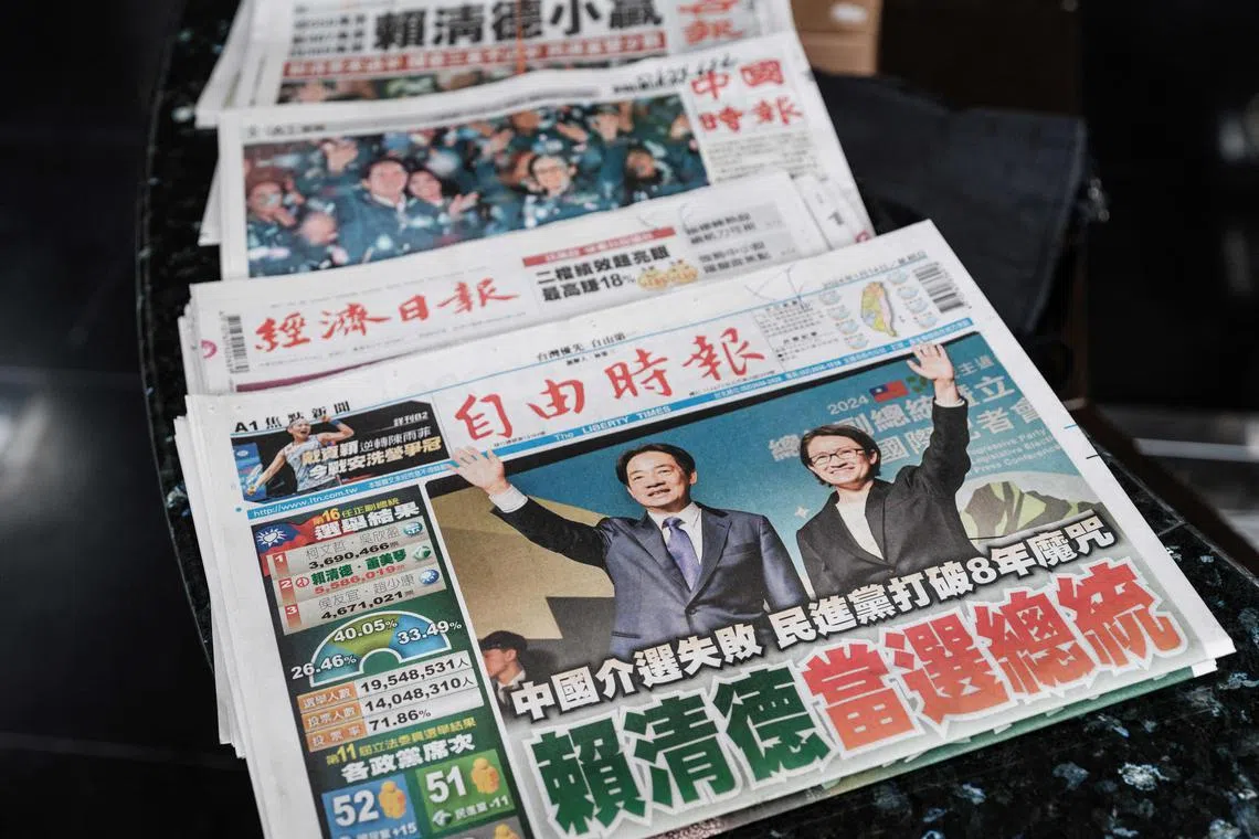 Local newspapers with the ruling Democratic Progressive Party's (DPP) victory in the presidential election on the front pages remain on the counter at the reception of an office building in Taipei on January 14, 2024. (Photo by Yasuyoshi CHIBA / AFP)