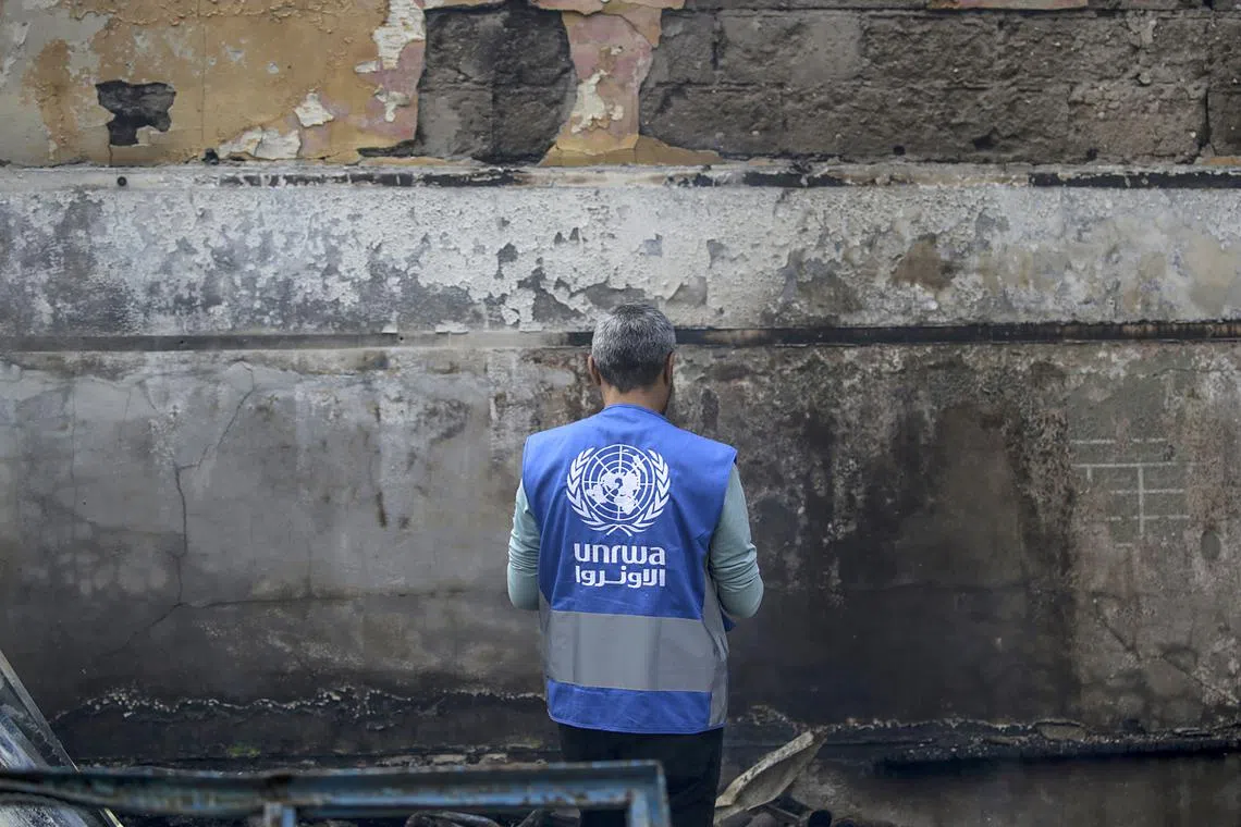 A UNRWA employee inspects a destroyed United Nations school following an air strike in the Al Nuseirat refugee camp, in the central Gaza Strip, on May 14, 2024.  