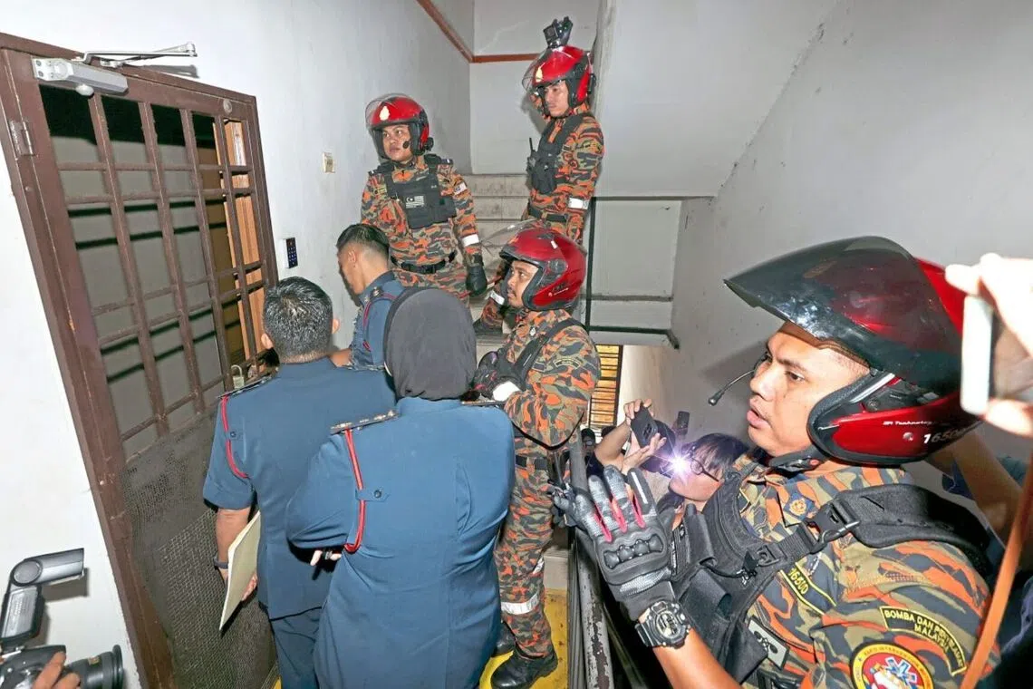 Fire and Rescue Department personnel attempting to enter a suspected bird’s nest hostel in Johor Bahru.