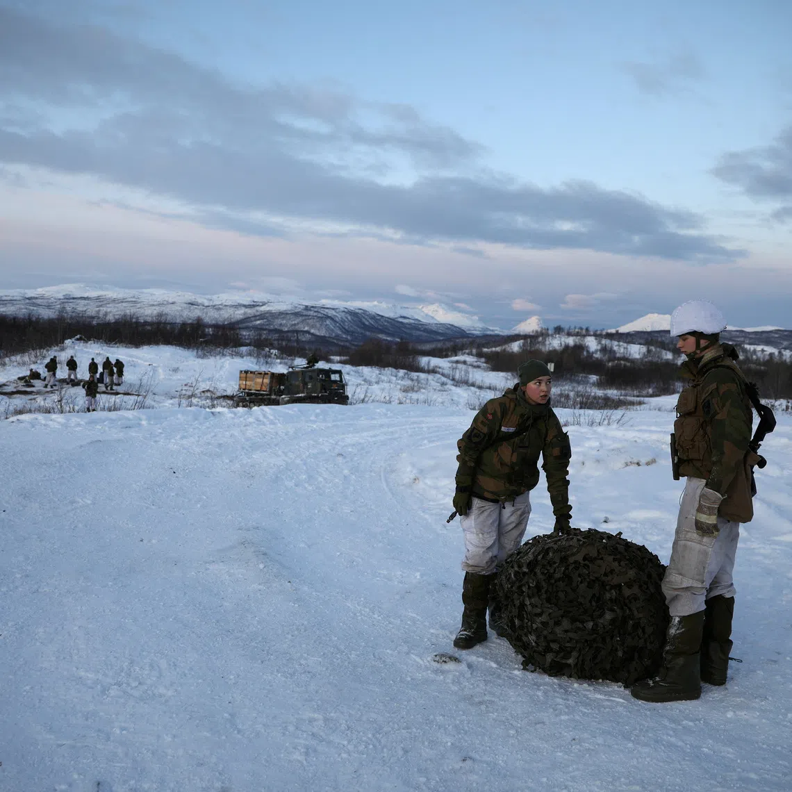 FILE PHOTO: Soldiers from the Combat Support Squadron of the First Battalion of the Northern Brigade of the Norwegian Army pack their camp in the morning during \"Reindeer 2\" Norwegian-U.S. military drill in Setermoen, Norway, October 30, 2019. REUTERS/Stoyan Nenov/File Photo