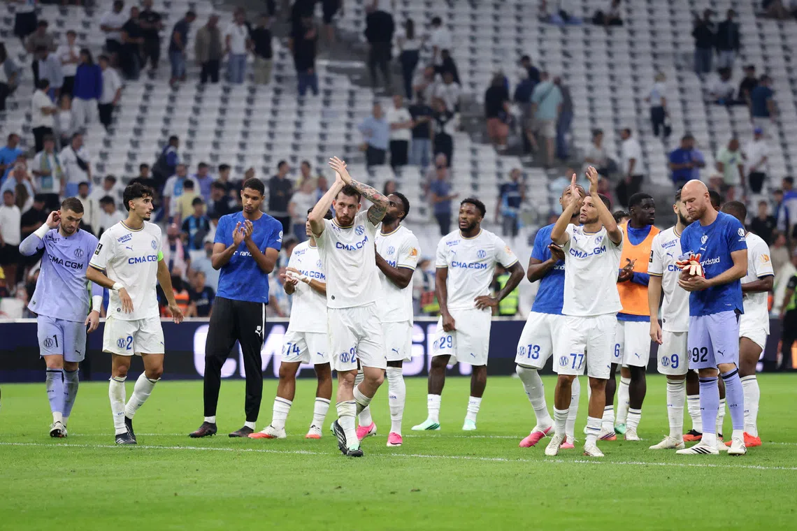 Soccer Football - Ligue 1 - Olympique de Marseille v Paris St Germain - Orange Velodrome, Marseille, France - September 20, 2026 Olympique de Marseille's Pierre-Emile Hojbjerg with teammates look dejected after the match REUTERS/Alexandre Dimou