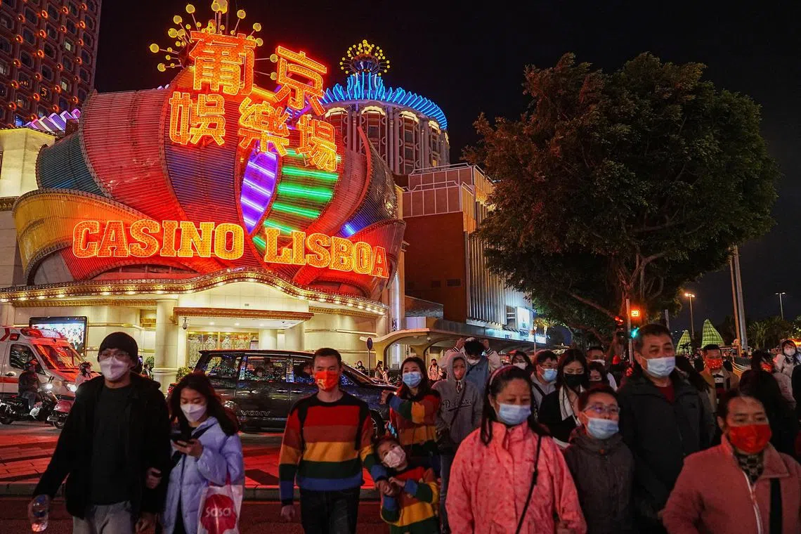 FILE PHOTO: Visitors walk past the Casino Lisboa operated by SJM Holdings during Lunar New Year in Macau, China, January 24, 2023. REUTERS/Lam Yik/File Photo
