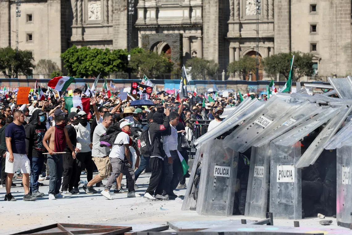 Demonstrators clash with police officers during a protest on Nov 15 in Mexico City. 